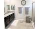Elegant bathroom with granite countertops and a walk-in shower at 5450 Sunshine Dr, Wildwood, FL 34785