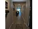 Long hallway leading to the living area with tile flooring at 5450 Sunshine Dr, Wildwood, FL 34785