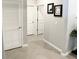 Hallway with tile flooring, white doors, and neutral walls at 5450 Sunshine Dr, Wildwood, FL 34785