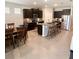 Spacious kitchen with island, dark cabinets, and granite countertops at 5450 Sunshine Dr, Wildwood, FL 34785
