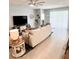 Bright and spacious living room with large windows and comfortable seating at 5450 Sunshine Dr, Wildwood, FL 34785