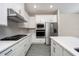 Modern kitchen featuring white cabinets, stainless steel appliances, and quartz countertops at 7748 Somersworth Dr, Kissimmee, FL 34747
