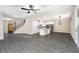 Open concept living area with grey vinyl plank flooring and a view into the kitchen at 7748 Somersworth Dr, Kissimmee, FL 34747