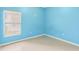 A bright bedroom featuring a window with blinds, light blue walls, and tile flooring at 4026 Navigator Way, Kissimmee, FL 34746