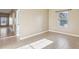 Sunlit bedroom with tile floors, neutral colors, and a large window at 4026 Navigator Way, Kissimmee, FL 34746