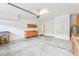 An open garage with storage cabinets, and a finished, clean concrete floor at 4026 Navigator Way, Kissimmee, FL 34746