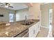 Open kitchen features granite countertops, stainless steel appliances, and convenient breakfast bar at 4026 Navigator Way, Kissimmee, FL 34746