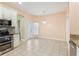 Bright kitchen boasts tile flooring, stainless steel appliances, and access to the outdoor patio at 4026 Navigator Way, Kissimmee, FL 34746