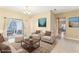 Staged living room featuring tile floor, modern furnishings, and neutral color palette at 4026 Navigator Way, Kissimmee, FL 34746