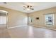 Spacious living room with tile flooring, ceiling fan, and natural light from windows at 4026 Navigator Way, Kissimmee, FL 34746