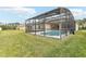 An eye-level view shows the fenced pool area and the yard's lush green grass at 4026 Navigator Way, Kissimmee, FL 34746