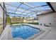 The backyard features a screened-in pool, offering a private and refreshing escape for relaxation at 4026 Navigator Way, Kissimmee, FL 34746