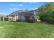 Large backyard with grassy area and screened-in pool at 213 Aidans Ldg, Haines City, FL 33844