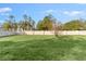 Large grassy backyard with a privacy fence at 213 Aidans Ldg, Haines City, FL 33844