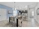 Open concept dining area with glass table and six chairs at 213 Aidans Ldg, Haines City, FL 33844