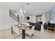Bright dining room with glass table and seating for six at 213 Aidans Ldg, Haines City, FL 33844
