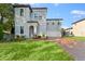 Two-story house with gray siding, brick driveway, and landscaped lawn at 213 Aidans Ldg, Haines City, FL 33844