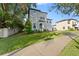 Two-story house with gray siding, a brick driveway, and lush green lawn at 213 Aidans Ldg, Haines City, FL 33844