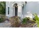 Inviting front entrance with arched entryway and landscaping at 213 Aidans Ldg, Haines City, FL 33844