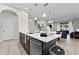 Modern kitchen features stainless steel appliances and an island with seating at 213 Aidans Ldg, Haines City, FL 33844