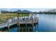 Lakeside gazebo with wooden deck and seating at 213 Aidans Ldg, Haines City, FL 33844