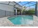 Inviting screened-in pool with stone deck at 213 Aidans Ldg, Haines City, FL 33844
