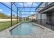 Relaxing screened-in pool with stone deck and water feature at 213 Aidans Ldg, Haines City, FL 33844