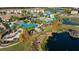 Aerial view of community pool, waterslide, and lake at 213 Aidans Ldg, Haines City, FL 33844