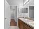 Double vanity bathroom with access to a walk-in closet at 10555 Leader Ln, Orlando, FL 32825