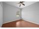 Well-lit bedroom featuring wood floors and a ceiling fan at 10555 Leader Ln, Orlando, FL 32825