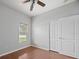 Well-lit bedroom with wood floors and double door closet at 10555 Leader Ln, Orlando, FL 32825