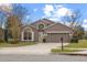 Two-story house with a two-car garage and a neatly landscaped lawn at 10555 Leader Ln, Orlando, FL 32825
