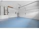 Garage with light blue floor and storage shelves at 10555 Leader Ln, Orlando, FL 32825