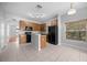 Kitchen with wood cabinets, black appliances and an island at 10555 Leader Ln, Orlando, FL 32825