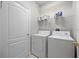 Laundry room with washer, dryer, and shelving at 10555 Leader Ln, Orlando, FL 32825