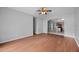 Living room with hardwood floors and an open view to the kitchen at 10555 Leader Ln, Orlando, FL 32825