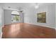 Living room with hardwood floors, large window, and ceiling fan at 10555 Leader Ln, Orlando, FL 32825