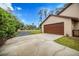 Brown garage door and long driveway at 15241 Colley Dr, Tavares, FL 32778