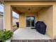 Covered patio with grill and sliding glass door at 2130 Sequoia Way, Davenport, FL 33896