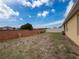 Brick wall enclosed backyard with small grassy area at 2130 Sequoia Way, Davenport, FL 33896