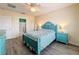 Serene bedroom with teal furniture, ceiling fan, and access to bathroom at 2130 Sequoia Way, Davenport, FL 33896