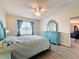 Guest bedroom with teal dresser, ceiling fan, and view of additional room at 2130 Sequoia Way, Davenport, FL 33896