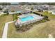 Community pool with surrounding lounge chairs and palm trees at 2130 Sequoia Way, Davenport, FL 33896