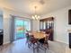 Bright dining room with wooden table, glass-front hutch, and access to backyard at 2130 Sequoia Way, Davenport, FL 33896