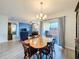Open dining room features a wooden table, slider to patio, and view of living room at 2130 Sequoia Way, Davenport, FL 33896