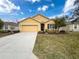 Single-story house with attached garage and landscaped lawn at 2130 Sequoia Way, Davenport, FL 33896