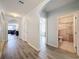 Light and airy hallway with wood-look flooring at 2130 Sequoia Way, Davenport, FL 33896