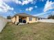 Back exterior view of house with covered patio and yard at 2130 Sequoia Way, Davenport, FL 33896