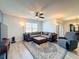 Relaxing living room with sectional sofa, ceiling fan, and wood-look floors at 2130 Sequoia Way, Davenport, FL 33896