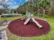 Community playground with two slides and soft surface at 2130 Sequoia Way, Davenport, FL 33896